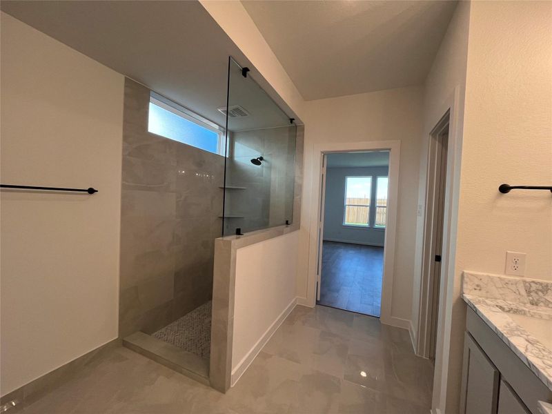 The bathroom features a custom mudset shower for a durable and stylish finish.