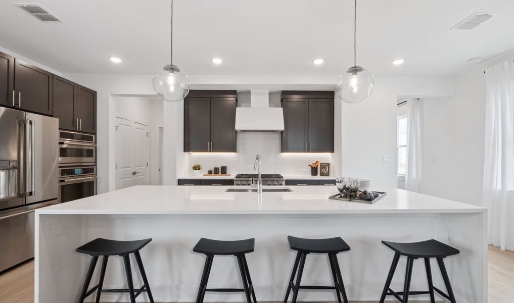Kitchen with waterfall-edge central island Kitchen with waterfall-edge central island