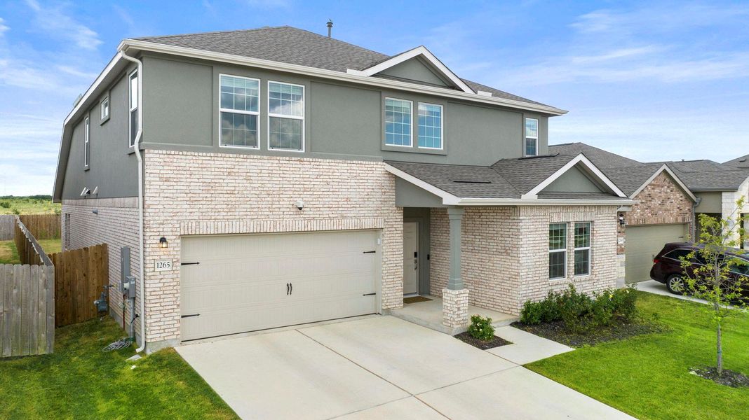 A contemporary two-story residence presents a sophisticated façade of light-toned brick and stucco, complemented by a neatly paved driveway. A contemporary two-story residence presents a sophisticated façade of light-toned brick and stucco, complemented by a neatly paved driveway.