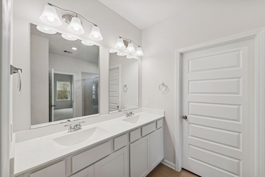 The Cardinal II- Primary Bathroom with Dual Vanities. Photos of home shown are for illustration only; actual features, colors, and upgrades may vary.