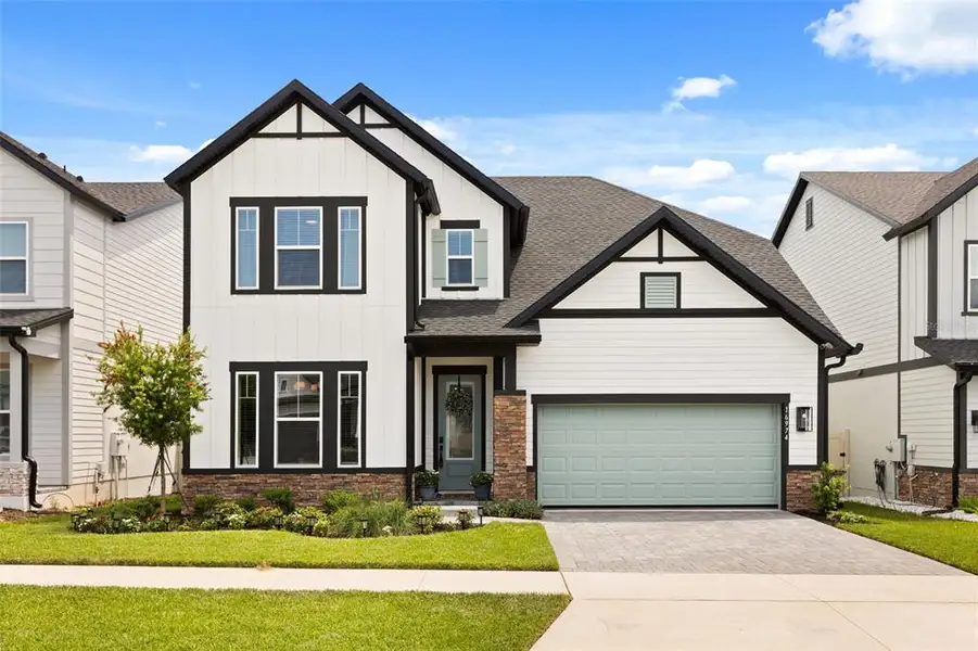 Front exterior of a new home in , Clermont, FL, highlighting curb appeal (Image 1). Front exterior of a new home in , Clermont, FL, highlighting curb appeal (Image 1).