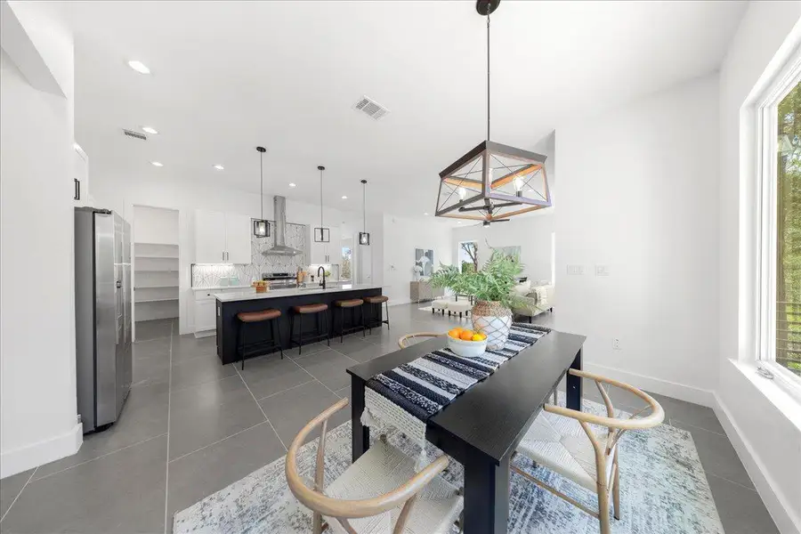 Dining area featuring plenty of natural light, tile patterned flooring, and recessed lighting Dining area featuring plenty of natural light, tile patterned flooring, and recessed lighting