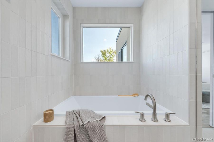 Soaking tub in Primary Bath's wet room