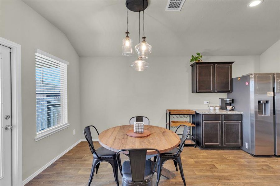 Breakfast nook with a coffee bar, lots of natural lighting and access to the covered back patio.