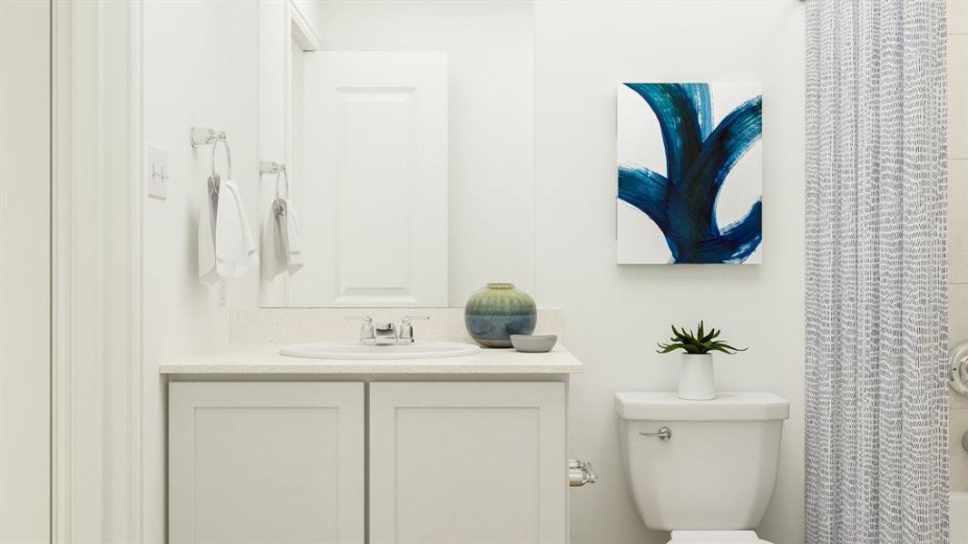 Full bathroom featuring vanity, shower / bath combo, and toilet