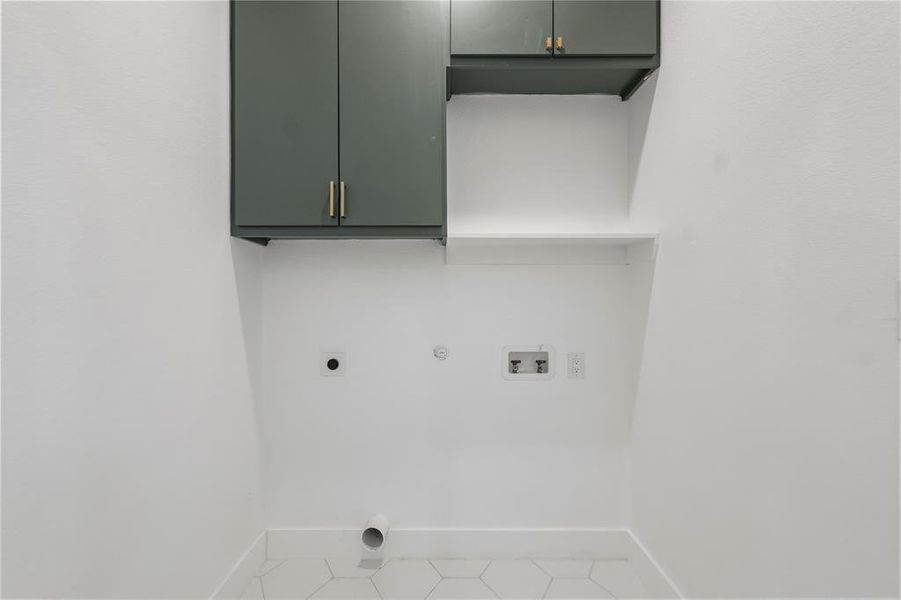 Clothes washing area featuring hookup for a washing machine, hookup for an electric dryer, cabinet space, baseboards, and hookup for a gas dryer