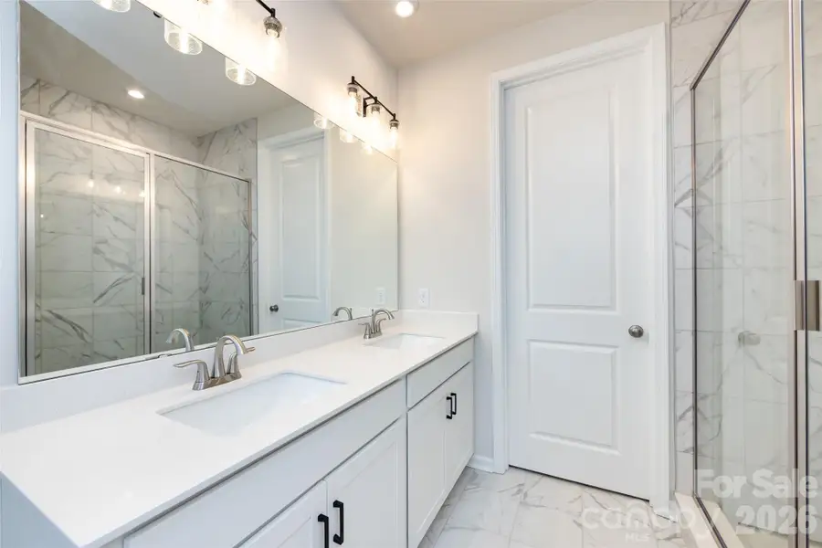 Primary Bathroom with White Cabinets and Quartz Countertop