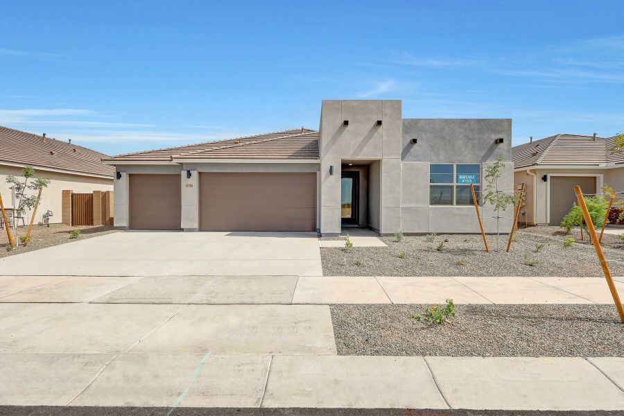 Front exterior of a new home in Miravida, Surprise, AZ, highlighting curb appeal (Image 1).