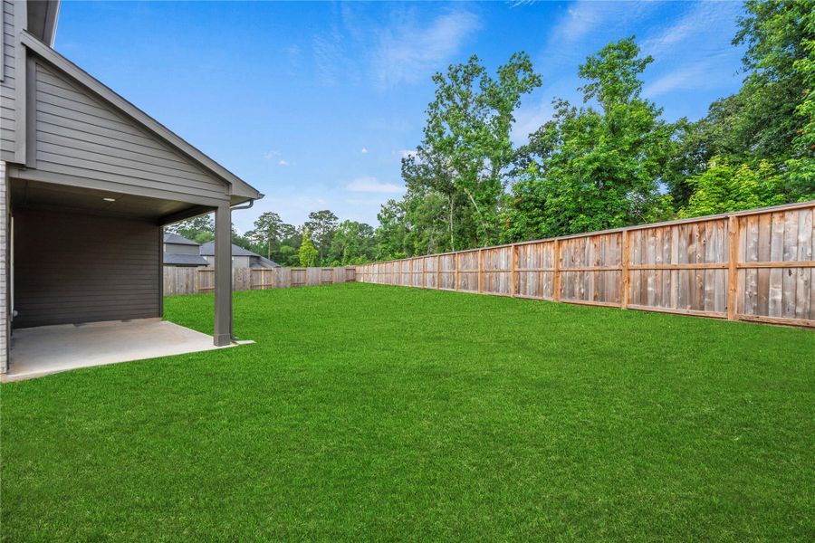 Huge backyard with a covered patio. Grass has been digitally enhanced to show potential. Huge backyard with a covered patio. Grass has been digitally enhanced to show potential.