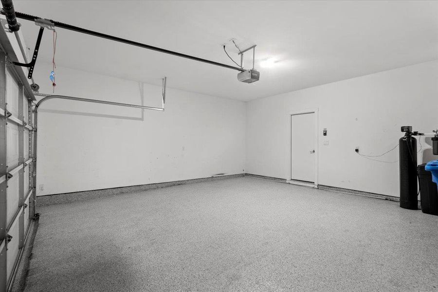A spacious garage with a durable epoxy floor and convenient direct home access.