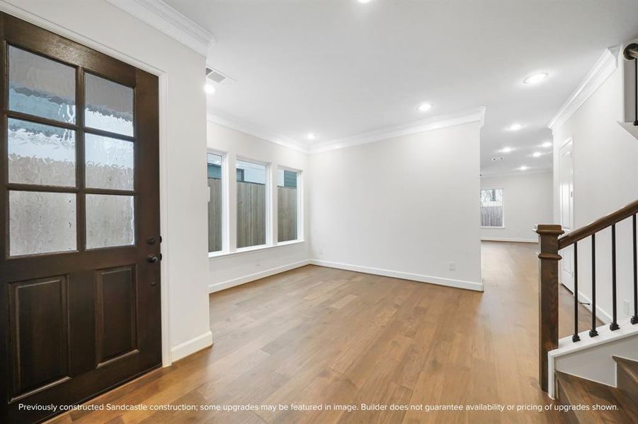 From another angle, the dining room reveals its generous proportions, ready to host your gatherings with grace and doors that open to welcome you home.