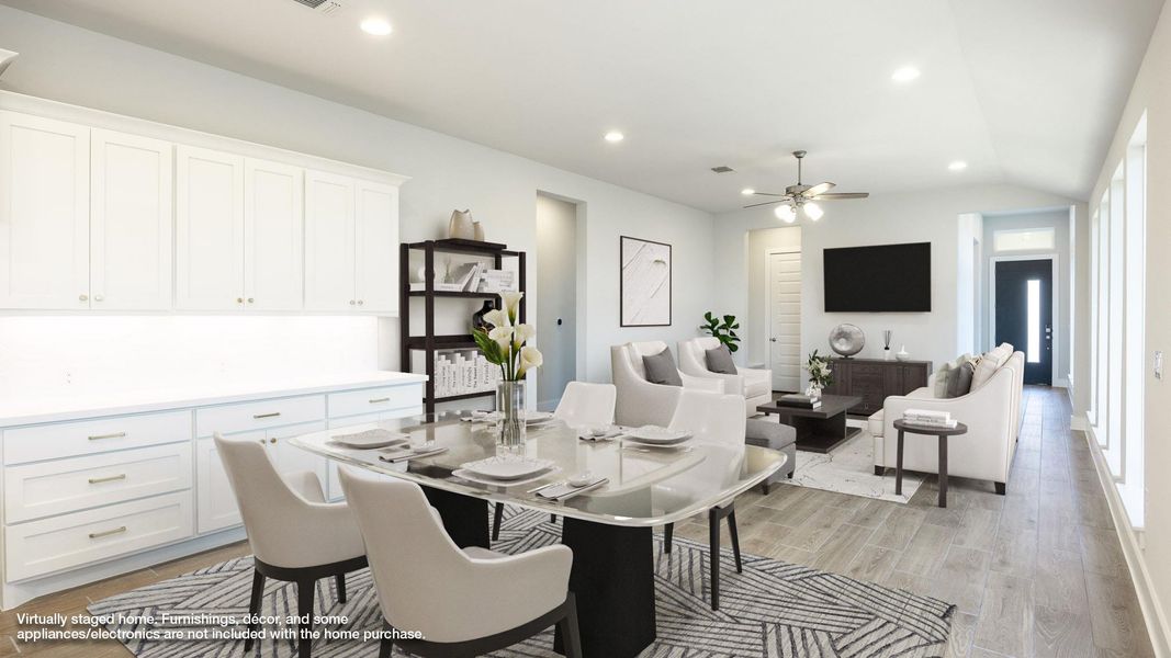 Dining space featuring lofted ceiling, recessed lighting, light wood finished floors, and a ceiling fan