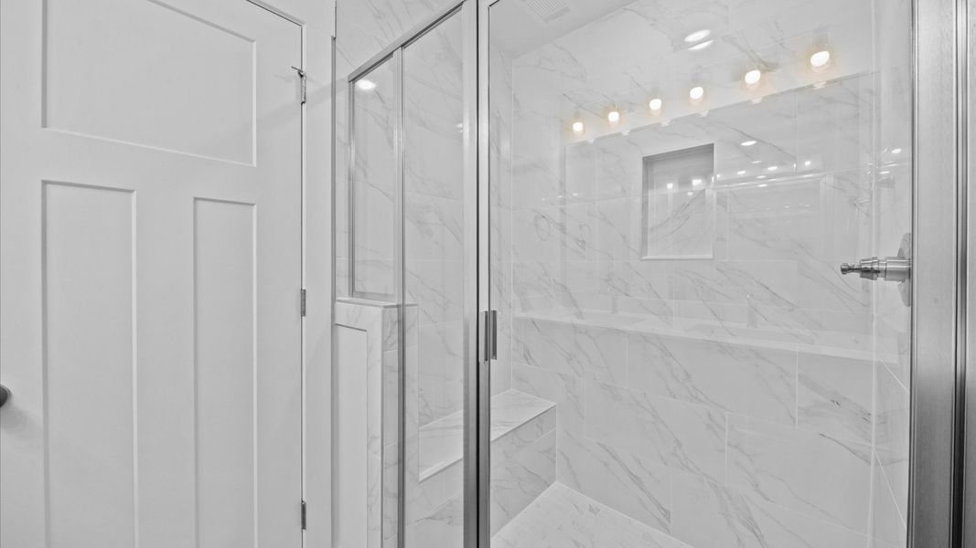 Marble tiled walk-in shower in two story townhome at Ransdell Pointe by DRB Homes in Spartanburg, SC