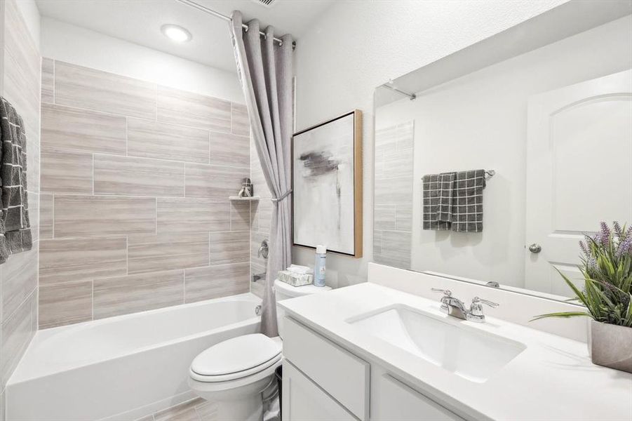 Full bathroom with shower / tub combo and vanity