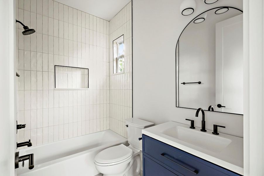 Full bathroom featuring toilet, shower / tub combination, and vanity