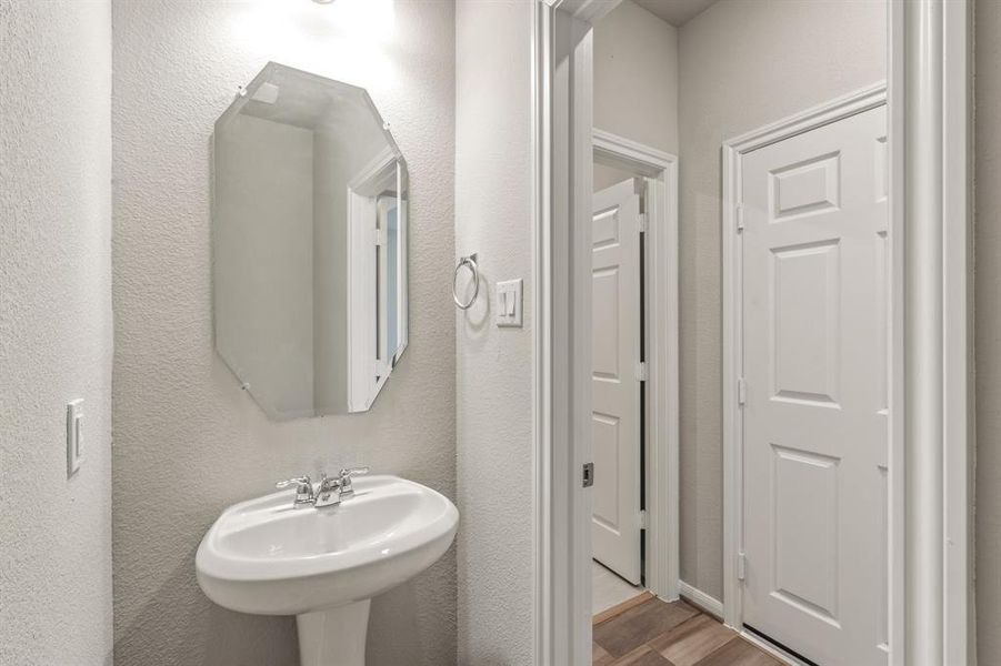 This charming home features a beautifully appointed half bath adjacent to the family room, perfect for welcoming guests and adding convenience to your daily life.