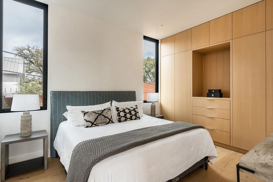 Minimalist bedroom design features built-in storage and large windows for natural light. Minimalist bedroom design features built-in storage and large windows for natural light.