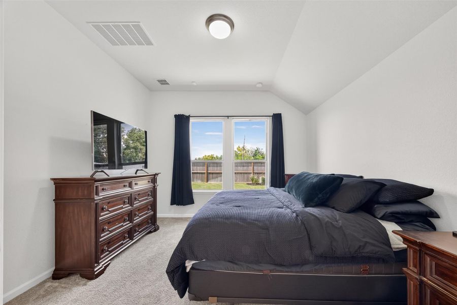 This beautiful primary bedroom features neutral color palette and carpeted floors, creating a warm and inviting atmosphere. This beautiful primary bedroom features neutral color palette and carpeted floors, creating a warm and inviting atmosphere.