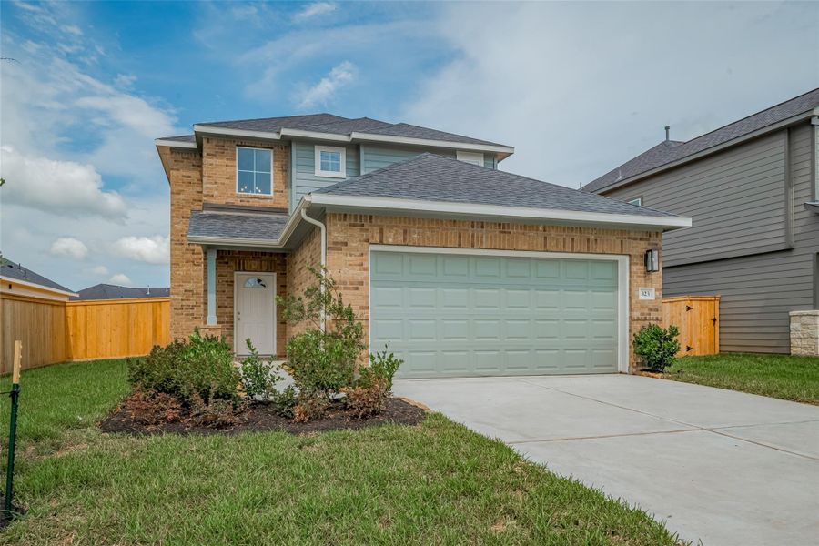 Front exterior of a new home in La Segarra, Brookshire, TX, highlighting curb appeal (Image 28).
