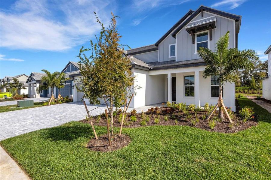 Front exterior of a new home in Hawkstone, Sarasota, FL, highlighting curb appeal (Image 25).