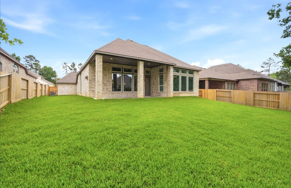 Exterior details and patio area of a home in The Woodlands Hills 65′, Willis (Image 25).