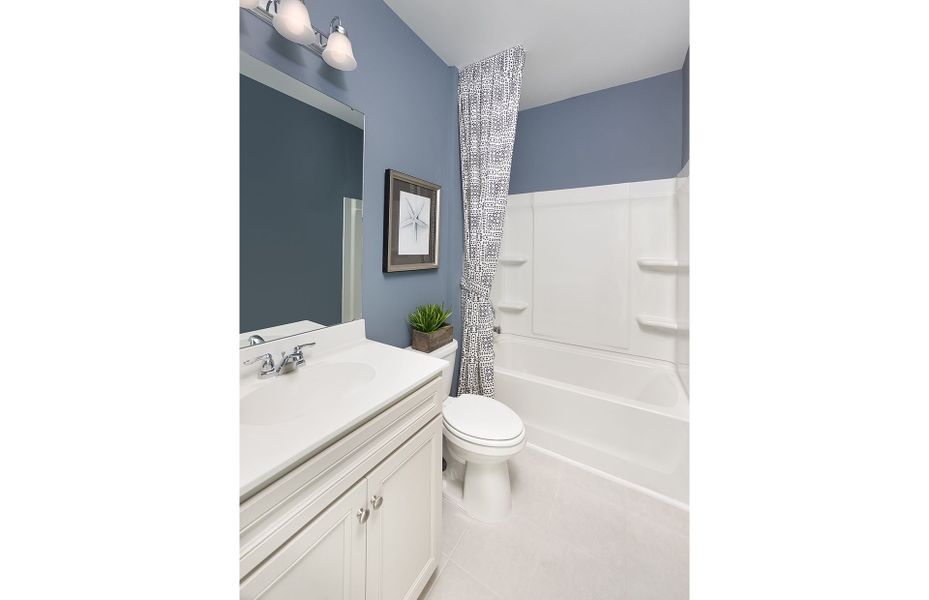 Secondary bathroom with a shower and tub. Model re