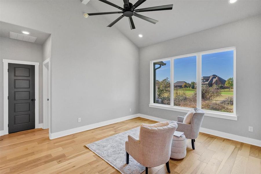 Sitting room with lofted ceiling, light wood-type flooring, recessed lighting, and a ceiling fan Sitting room with lofted ceiling, light wood-type flooring, recessed lighting, and a ceiling fan