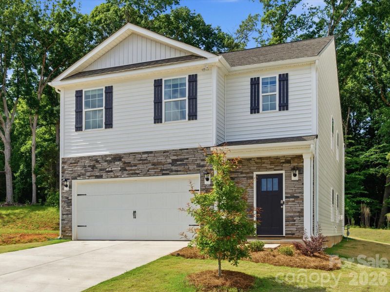 Front exterior of a new home in Reedy Creek Preserve, Charlotte, NC, highlighting curb appeal (Image 27).