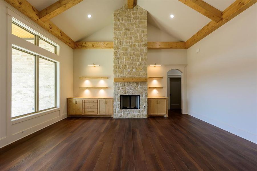 Unfurnished living room featuring a fireplace, dark wood finished floors, and recessed lighting Unfurnished living room featuring a fireplace, dark wood finished floors, and recessed lighting