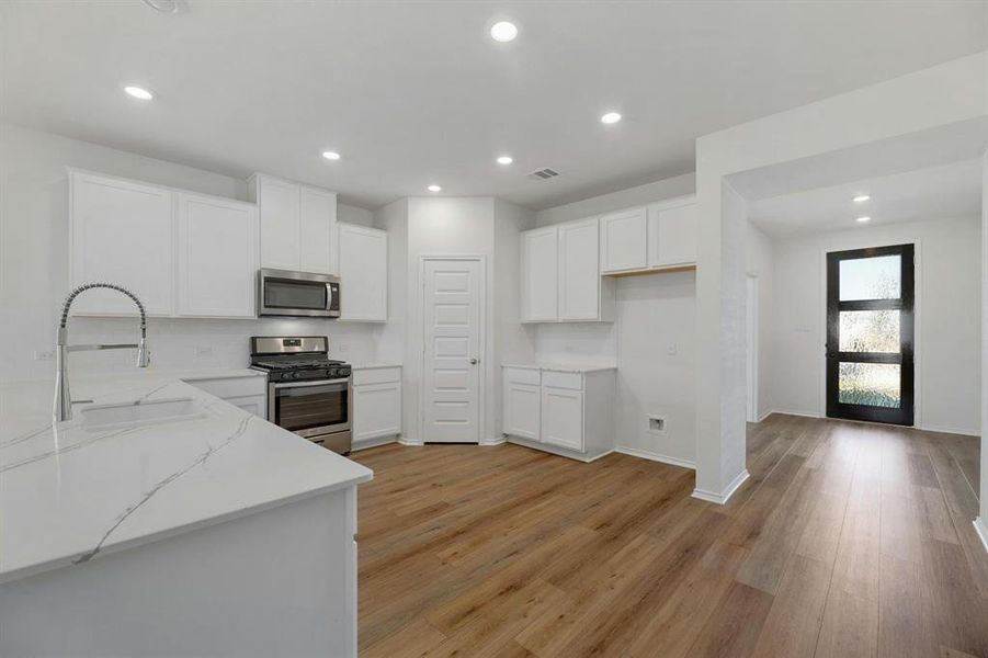 Efficiently positioned kitchen near the front door, offering convenience and a welcoming entry into the heart of the home.