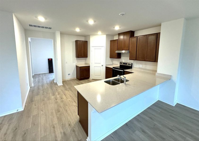 Kitchen with additional seating at breakfast bar