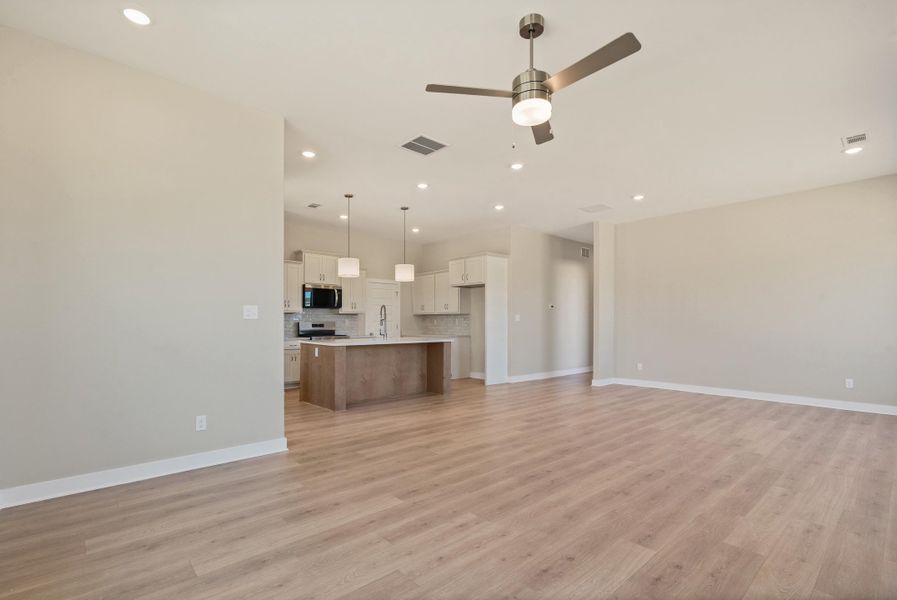 Unfurnished living room with a ceiling fan, light wood-type flooring, and recessed lighting