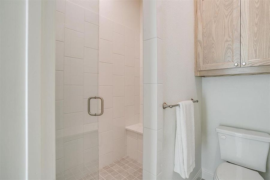 Bathroom featuring toilet and an enclosed shower