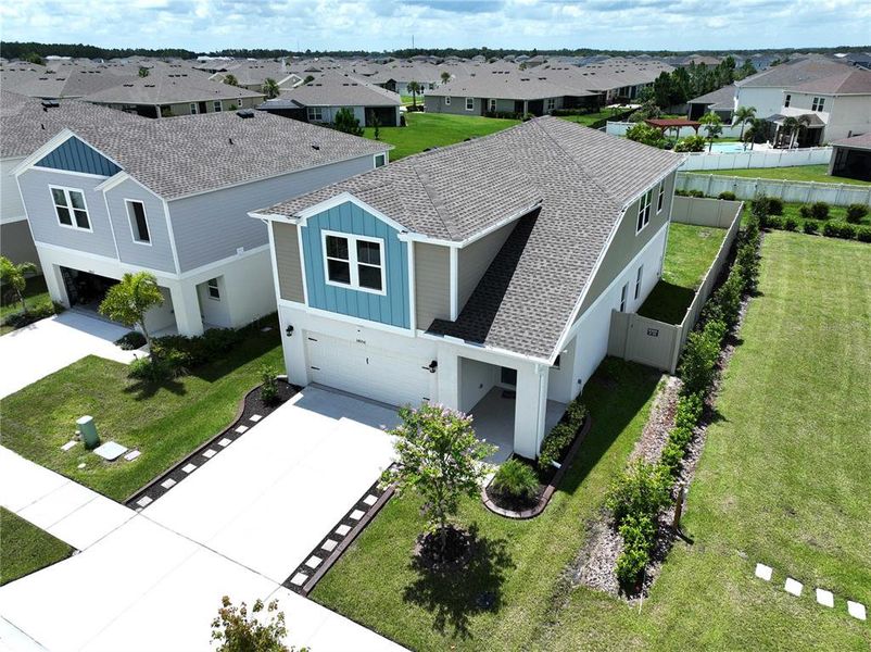 Front exterior of a new home in Pasadena Point, Wesley Chapel, FL, highlighting curb appeal (Image 27). Front exterior of a new home in Pasadena Point, Wesley Chapel, FL, highlighting curb appeal (Image 27).