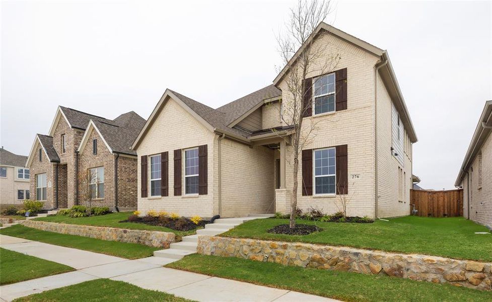Front exterior of a new home in Edgewater, Fate, TX, highlighting curb appeal (Image 1). Front exterior of a new home in Edgewater, Fate, TX, highlighting curb appeal (Image 1).