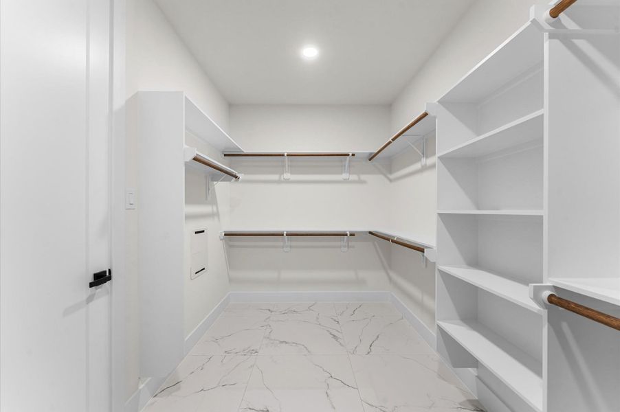 Primary bedroom walk-in closet Primary bedroom walk-in closet
