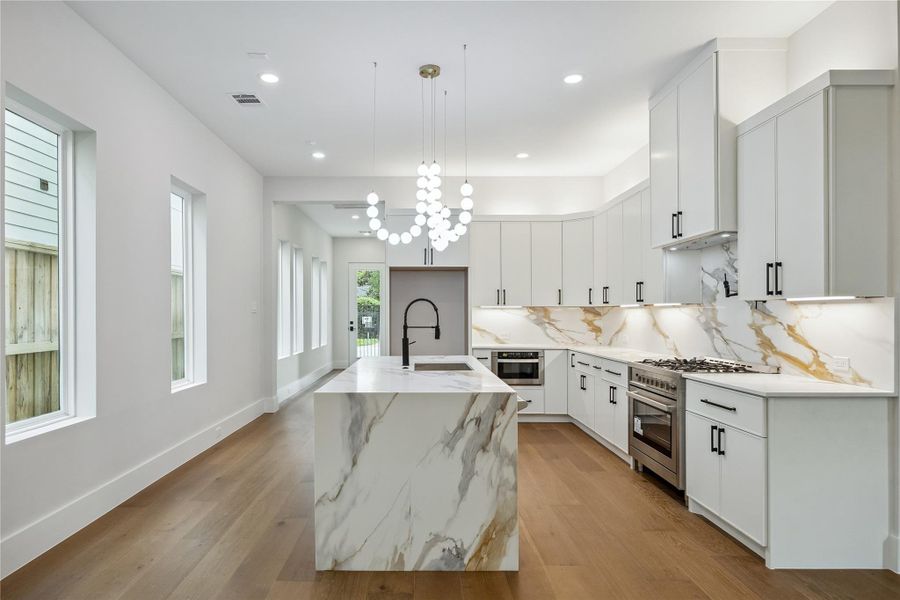 The kitchen combines modern features with a layout centered around functionality and flow. Layered lighting, quartz surfaces, and professional-style appliances create a space that feels polished without feeling overdone. The kitchen combines modern features with a layout centered around functionality and flow. Layered lighting, quartz surfaces, and professional-style appliances create a space that feels polished without feeling overdone.