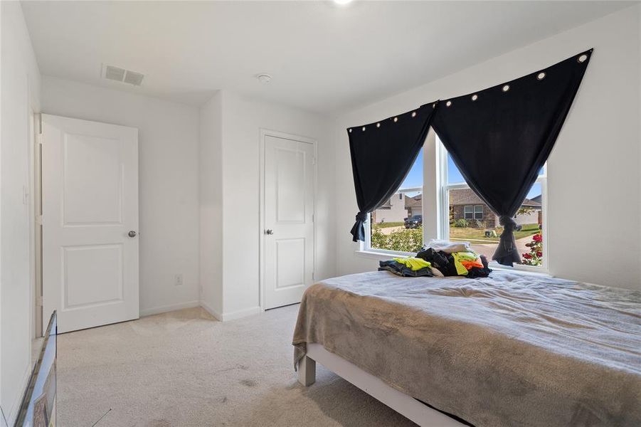 Bedroom featuring carpet and baseboards