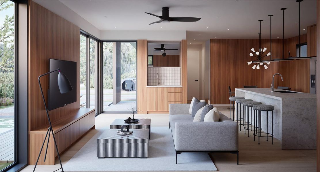 Living area with light wood finished floors, a ceiling fan, and wood walls Living area with light wood finished floors, a ceiling fan, and wood walls