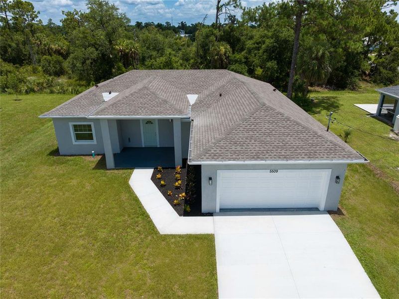 Front exterior of a new home in , North Port, FL, highlighting curb appeal (Image 25). Front exterior of a new home in , North Port, FL, highlighting curb appeal (Image 25).