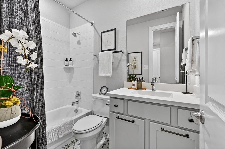 Full bath featuring shower / tub combo with curtain and vanity Full bath featuring shower / tub combo with curtain and vanity