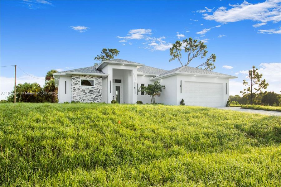 Front exterior of a new home in , Lehigh Acres, FL, highlighting curb appeal (Image 2).
