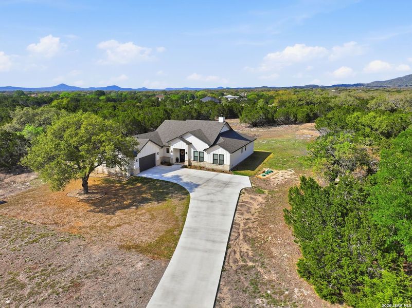 Front exterior of a new home in , Bandera, TX, highlighting curb appeal (Image 23).