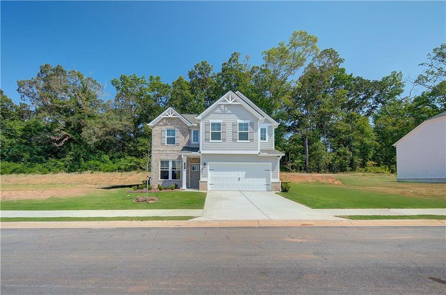 Front exterior of a new home in Westminster, Covington, GA, highlighting curb appeal (Image 16). Front exterior of a new home in Westminster, Covington, GA, highlighting curb appeal (Image 16).