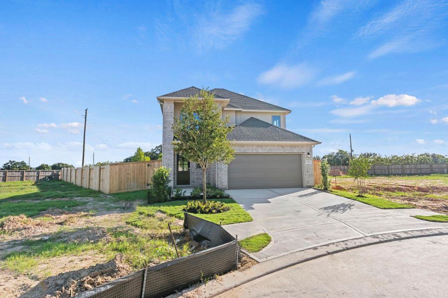 Front exterior of a new home in Candela, Richmond, TX, highlighting curb appeal (Image 23).