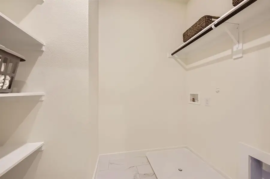 Laundry area with marble finish floors, hookup for a gas dryer, and washer hookup