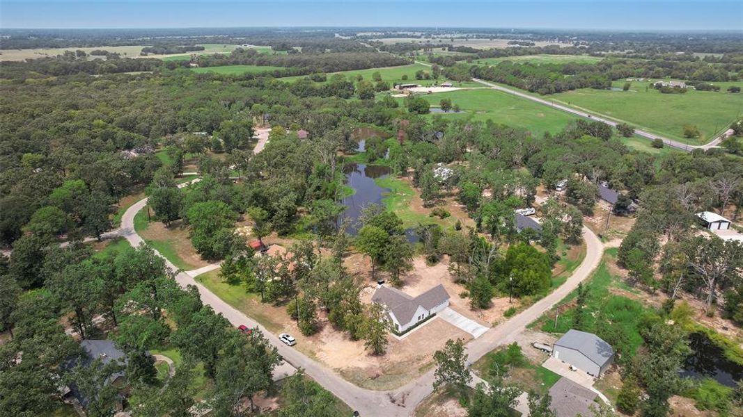 Aerial view of property's location with a large body of water and rural landscape