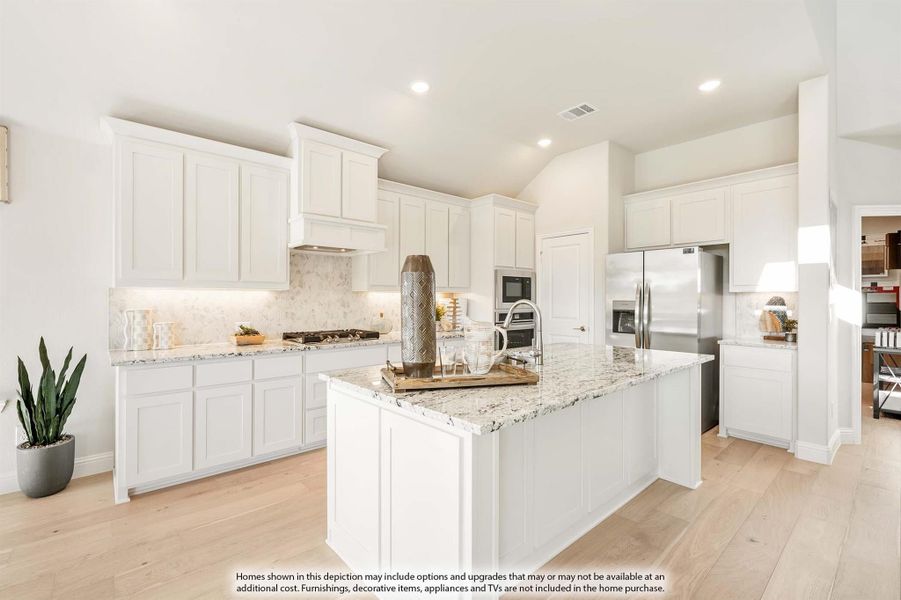 Kitchen with white cabinets, granite island, stone backsplash, and stainless steel appliances on light hardwood floors Kitchen with white cabinets, granite island, stone backsplash, and stainless steel appliances on light hardwood floors