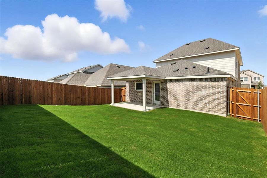Rear view of property featuring a patio, brick siding, a fenced backyard, and roof with shingles Rear view of property featuring a patio, brick siding, a fenced backyard, and roof with shingles