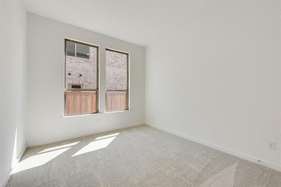 Unfurnished room featuring carpet flooring and baseboards Unfurnished room featuring carpet flooring and baseboards